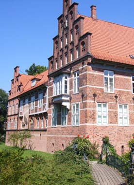 Eine schmiedeeiserne, mit Blumen geschmückte Brücke führt direkt zum Schloss