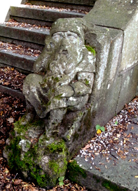 In den Sockel eines Stein-Treppengeländers ist ein Zwerg gearbeitet